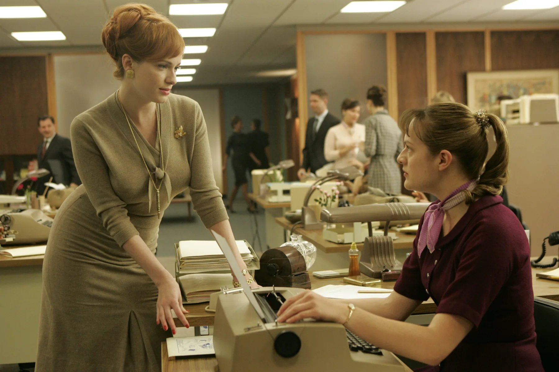 Joan Holloway speaks with a secretary in Sterling Cooper’s open office